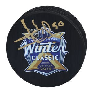 Signed hockey puck with the New York Rangers logo, commemorating the 10th Anniversary Winter Classic at Citi Field, 2018, featuring a gold signature on the front.