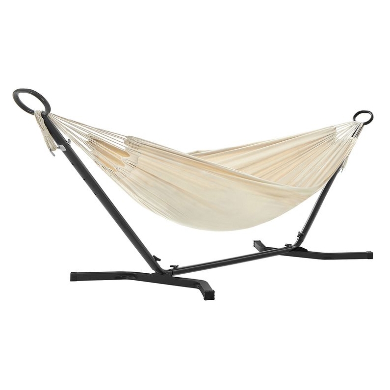 A beige double hammock is suspended on a sturdy, black metal stand with circular loops on each end for support.