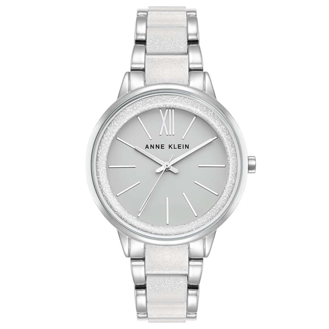 Anne Klein silver-tone watch with a white strap, features a minimalist design with a light grey dial, silver markers, and a Roman numeral XII.