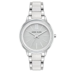 Anne Klein silver-tone watch with a white strap, features a minimalist design with a light grey dial, silver markers, and a Roman numeral XII.