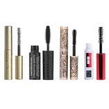 Four different mascaras with varied packaging and brush designs: gold tube with dense bristles, black tube with a flexible rubber brush, floral patterned tube with curled brush, and white and red tube with voluminous bristles.