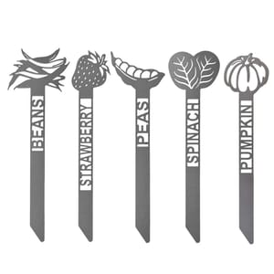 Garden plant markers for beans, strawberry, peas, spinach, and pumpkin, each featuring a cutout design of the respective plant above the name.