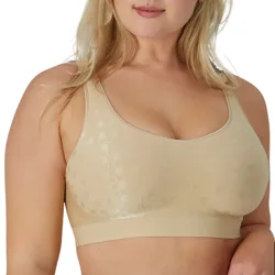 A woman wears a beige bra with a subtle circular pattern, featuring wide straps and a seamless design, providing full coverage and support.