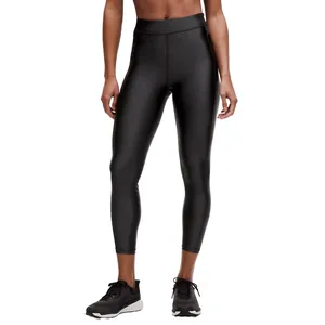 A person is wearing shiny black high-waisted leggings paired with black running sneakers.