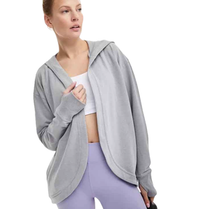Gray, relaxed-fit cardigan hoodie with a draped, curved open front, long sleeves, and a hood, paired with a white crop top and lavender leggings.