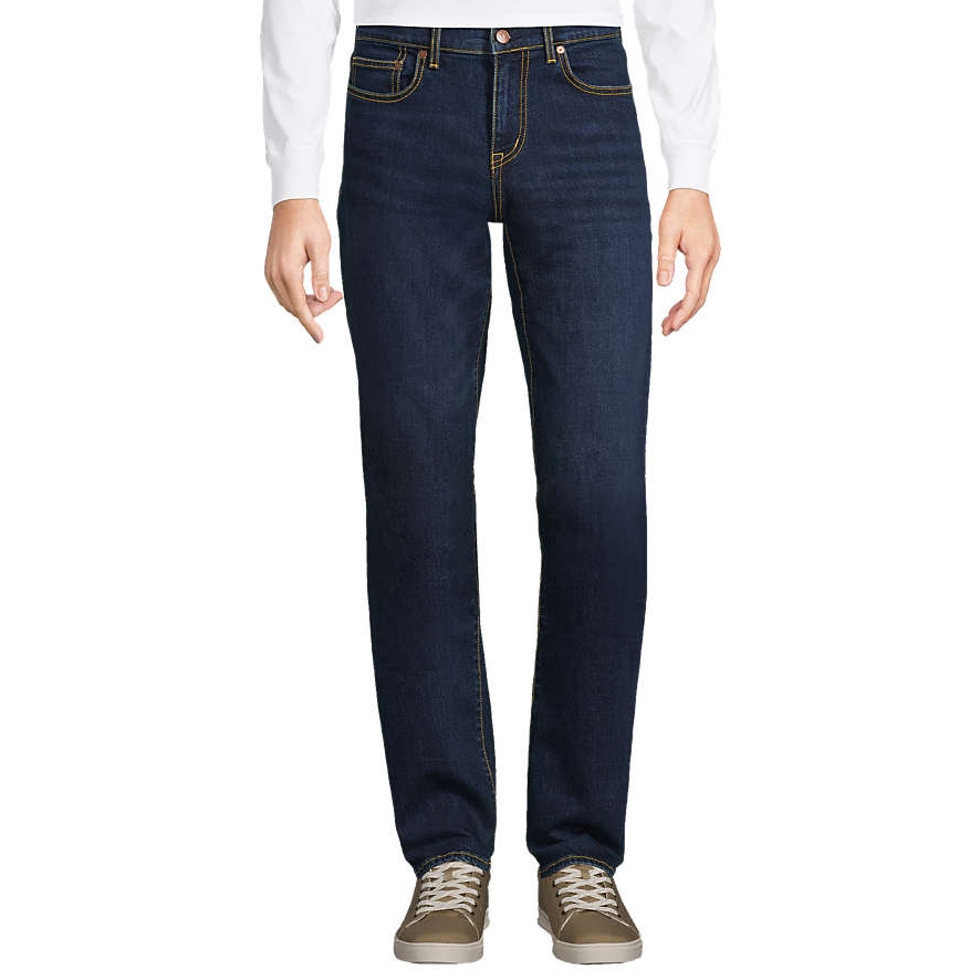 Lands' End Men's Recover Jeans are dark wash denim jeans featuring a straight leg fit, classic five-pocket styling, and yellow contrast stitching. They are paired with taupe sneakers and a white long-sleeve shirt.
