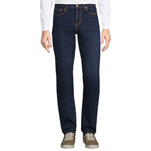 Lands' End Men's Recover Jeans are dark wash denim jeans featuring a straight leg fit, classic five-pocket styling, and yellow contrast stitching. They are paired with taupe sneakers and a white long-sleeve shirt.