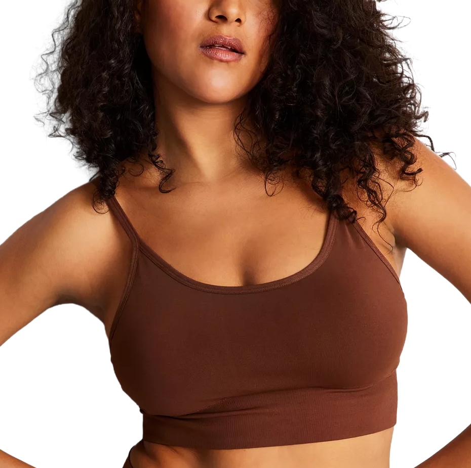 A person is wearing a brown spaghetti strap bralette, featuring a scoop neckline and a fitted, comfortable design.