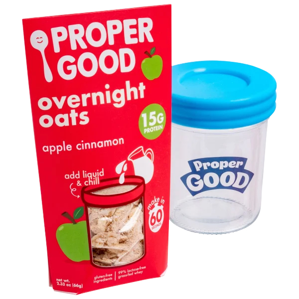 Proper Good Overnight Oats Kit includes a pack of apple cinnamon overnight oats with 15g protein and a reusable container with a blue lid. The oats are gluten-free and made with 99% lactose-free grass-fed whey.
