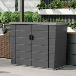A black outdoor storage cabinet with double doors is placed on a patio, surrounded by plants and outdoor furniture.