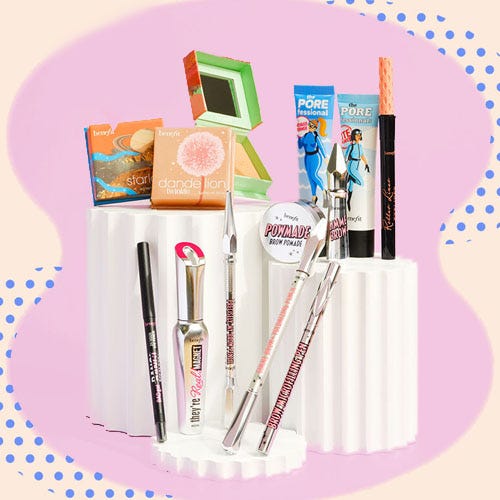 A variety of makeup items, including brushes, mascara, pencils, and powders, displayed with their packaging.