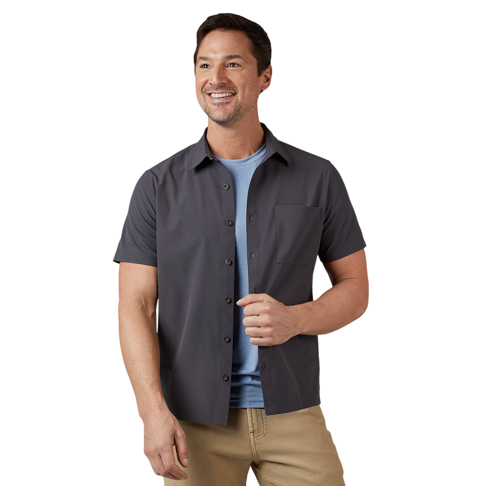 A man is wearing a short-sleeve, buttoned gray shirt over a light blue T-shirt, paired with beige pants.