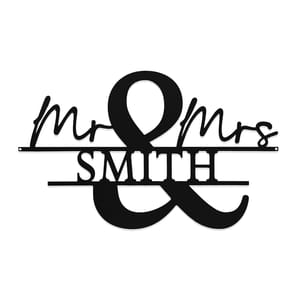 A black metal wall sign featuring \“Mr & Mrs Smith\“ in a mix of cursive and block letters, with an ampersand as a focal point.