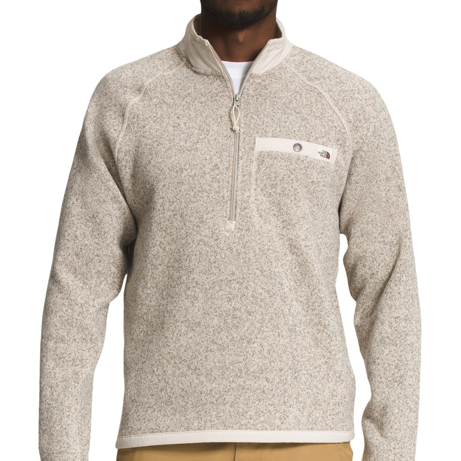 The North Face Gordon Lyons Jacket is a beige, speckled fleece pullover with a quarter-zip collar and a small zippered chest pocket, offering a casual yet functional design for cool weather.