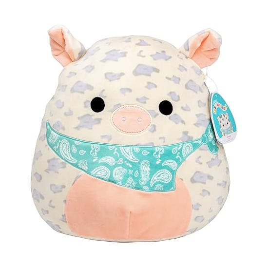 Plush cow toy with a paisley bandana patterned bib.