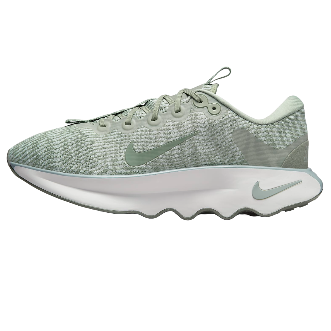 Light green Nike walking shoes with a textured upper, featuring Swoosh logos and a wavy sole design.