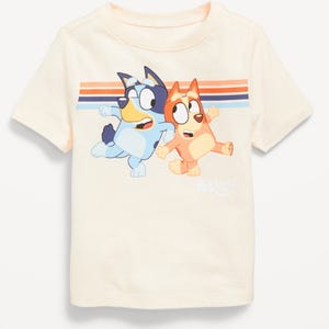 A cream-colored children's t-shirt with two animated dog characters printed on the front.