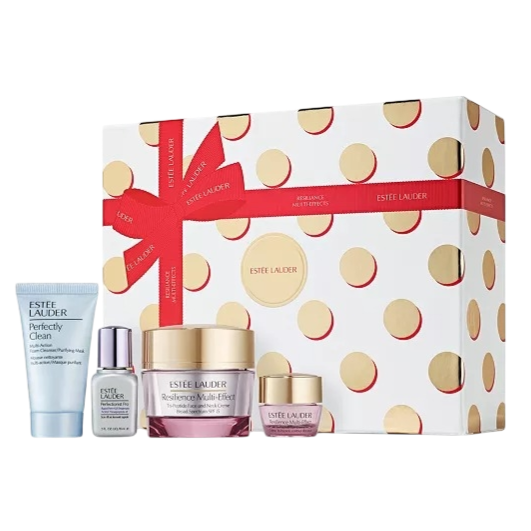 Estee Lauder gift set featuring Perfectly Clean cleanser, Advanced Night Repair serum, Resilience Multi-Effect face and eye creams, presented in a white box with gold polka dots and a red ribbon.