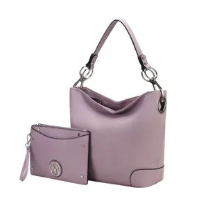 A lavender leather handbag with metallic ring accents and a matching zippered wristlet pouch featuring a round logo emblem.