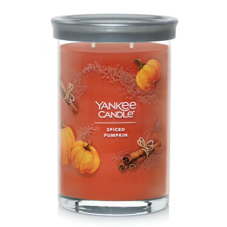 Yankee Candle with Spiced Pumpkin scent, orange wax in a glass jar with a metal lid.
