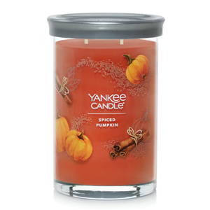 Yankee Candle with Spiced Pumpkin scent, orange wax in a glass jar with a metal lid.