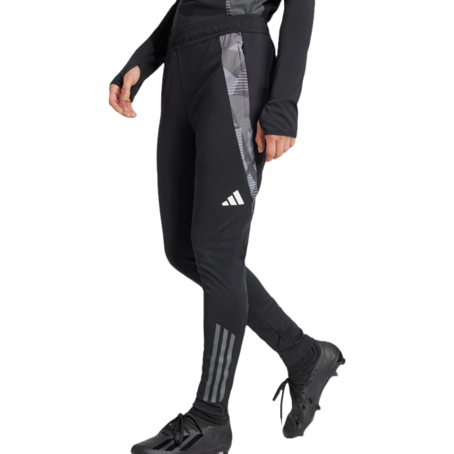 Adidas Women's Tiro 23 Training Pants are black, featuring a slim fit with a camo-patterned side stripe and the Adidas logo. They have elastic cuffs and three stripes at the lower leg, paired with black athletic shoes.