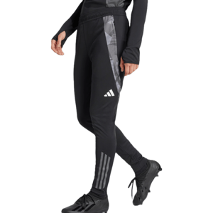 Adidas Women's Tiro 23 Training Pants are black, featuring a slim fit with a camo-patterned side stripe and the Adidas logo. They have elastic cuffs and three stripes at the lower leg, paired with black athletic shoes.