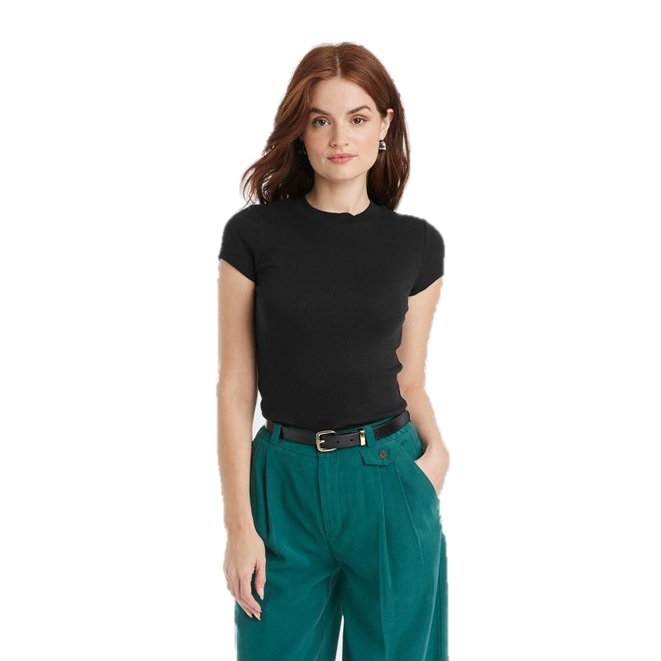 A woman is wearing a black short-sleeve top paired with high-waisted teal pants secured with a black belt.
