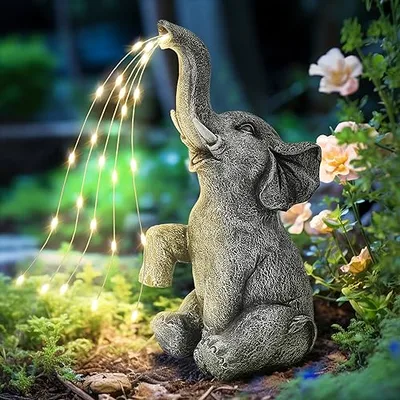 A decorative elephant statue with integrated LED lights, designed for garden or outdoor use, featuring a whimsical water spray effect.