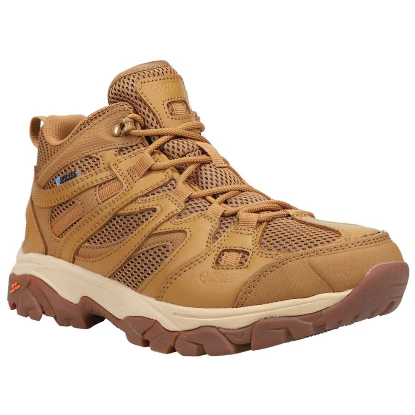 Tan hiking boots with mesh panels, sturdy soles, and a mid-top design, featuring a lace-up closure and branded detailing.
