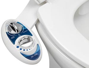A bidet attachment with control dials for adjustable water pressure and cleaning modes is installed on a toilet seat, labeled \“Neo 185\“ with options for frontal and rear cleaning.