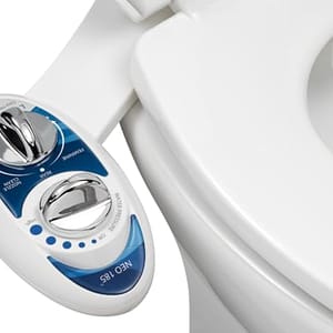 A bidet attachment with control dials for adjustable water pressure and cleaning modes is installed on a toilet seat, labeled \“Neo 185\“ with options for frontal and rear cleaning.