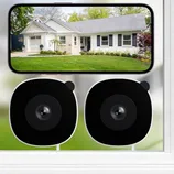 Two black surveillance cameras shown below a smartphone displaying a live feed of a house exterior with a lawn.