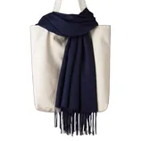 A cream-colored tote bag with two handles is adorned with a navy blue scarf featuring fringe detail.