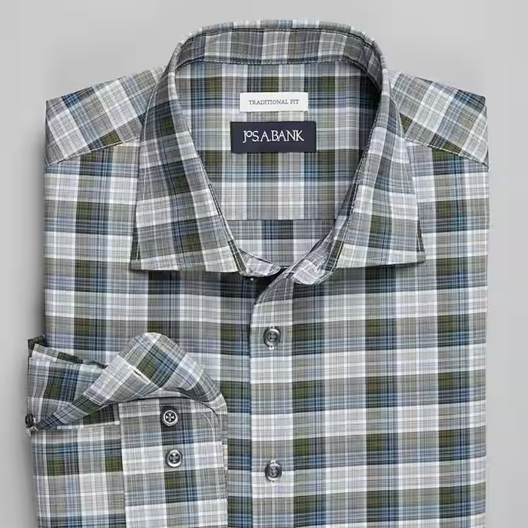 Plaid dress shirt in shades of white, grey, and green with a pointed collar and buttoned cuffs.