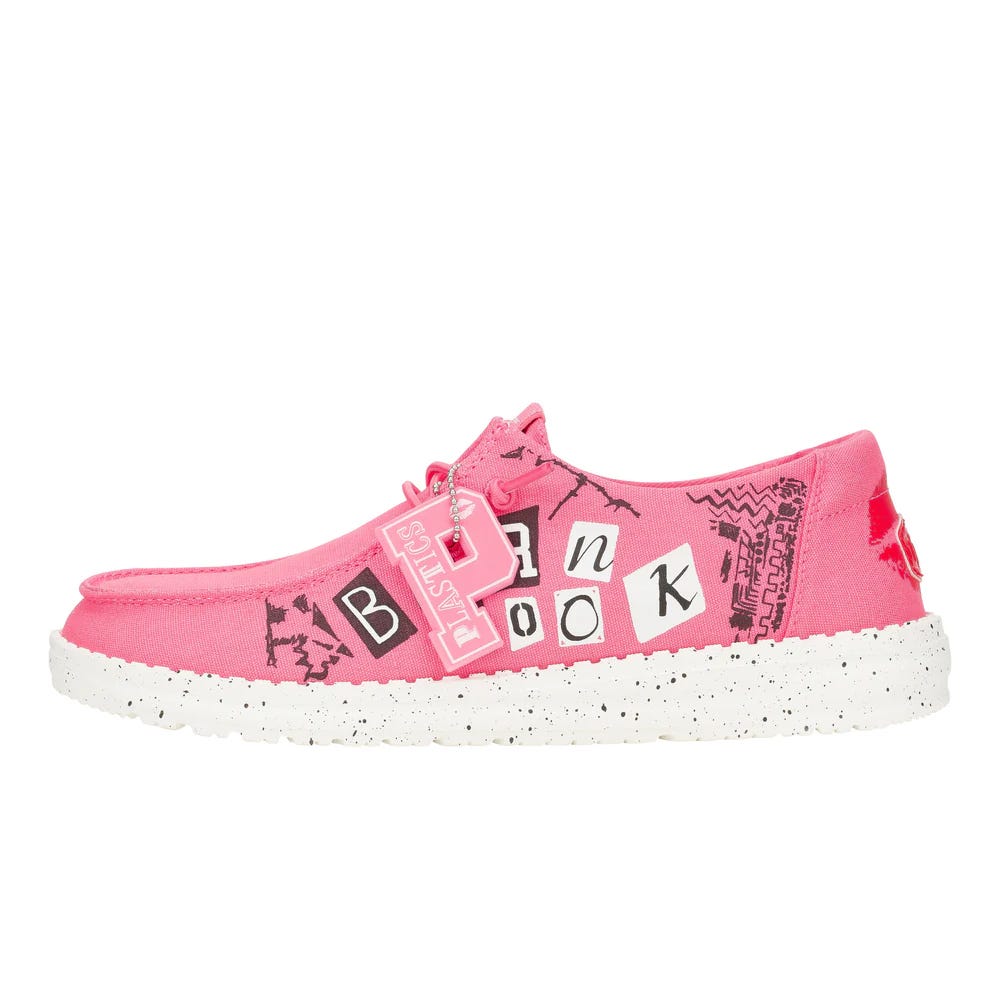 Pink shoe with ransom-note style letters spelling \“Burn Book\“ and a white speckled sole. A pink tag labeled \“Plastics\“ is attached near the laces.