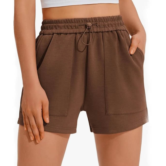 Brown high-waisted shorts with a drawstring waistband and pockets, paired with a white crop top.