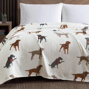 A plush queen blanket featuring a pattern of Labrador dogs wearing bandanas, set against a light background.