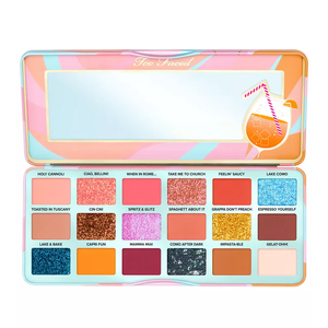 Too Faced Eye Shadow Palette features 18 shades, including a mix of matte, shimmer, and glitter finishes with names like \“Holy Cannoli,\“ \“Lake Como,\“ and \“Espresso Yourself.\“ The palette has a colorful design with a mirror inside.