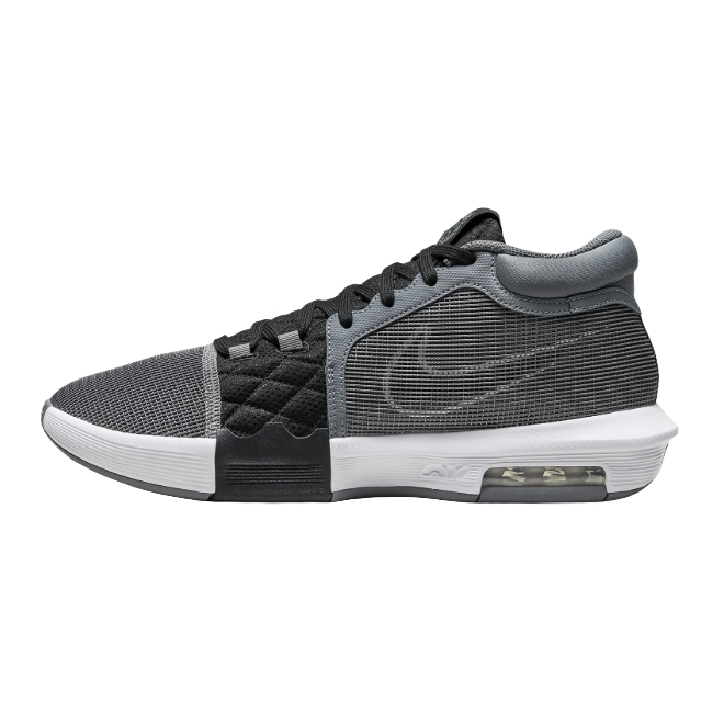 A black and gray Nike sneaker with a visible air cushion in the sole and a quilted section near the laces.