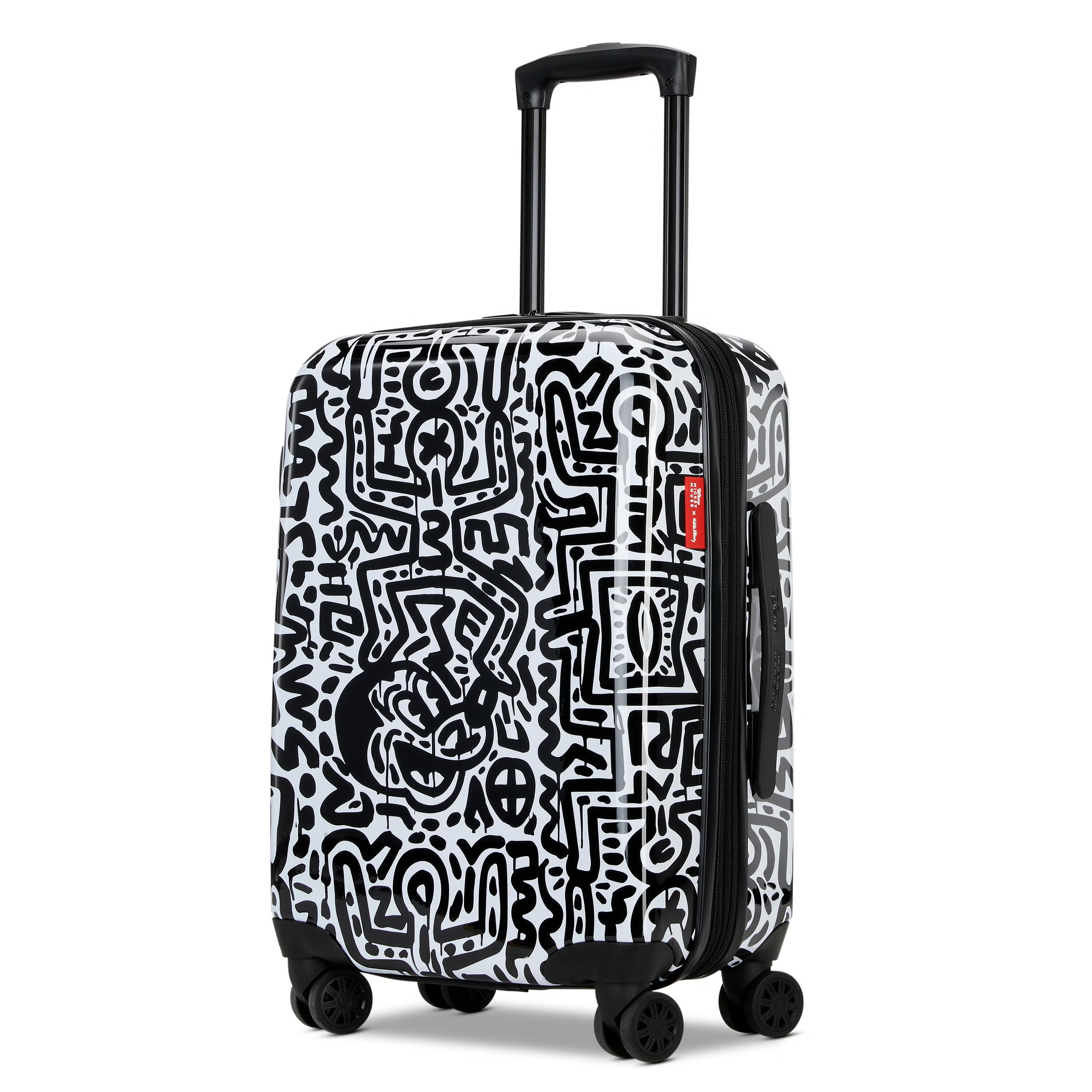 A carry-on suitcase featuring a black and white Keith Haring-inspired design with abstract, graffiti-style patterns and a motif of Disney's Mickey Mouse. Equipped with four spinner wheels and a retractable handle.
