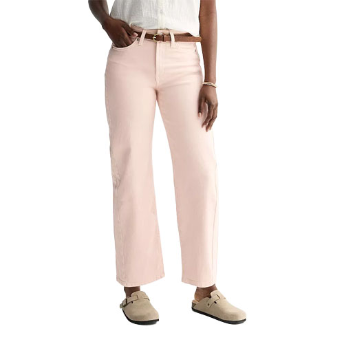 A person is wearing light pink wide-leg pants with a brown belt and beige slip-on shoes.