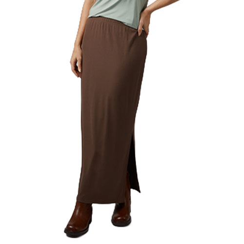 A person wearing a brown maxi skirt with a side slit, paired with dark brown boots and a light green top.