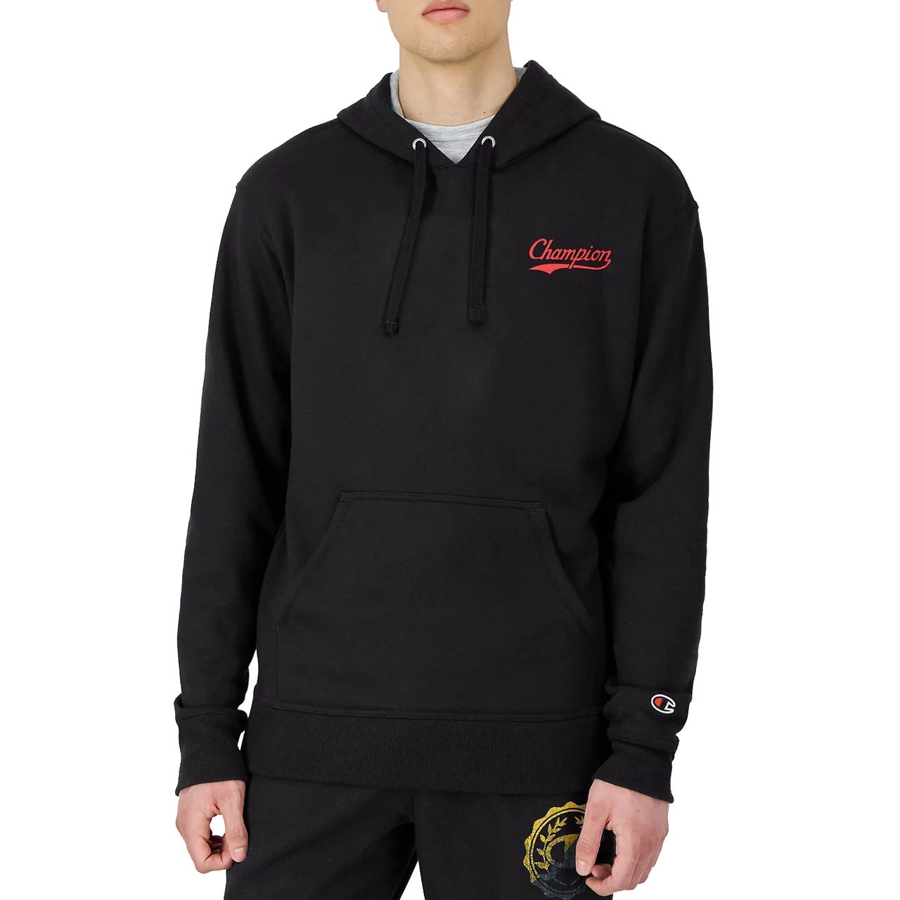 A black Champion hoodie with a red logo on the chest and a small logo on the sleeve. It features a drawstring hood and a front kangaroo pocket.