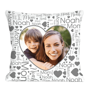 Heart-themed personalized throw pillow featuring a photo of a smiling woman and child, surrounded by the words \“Mom\“ and \“Noah\“ in various fonts, along with heart icons in grayscale.
