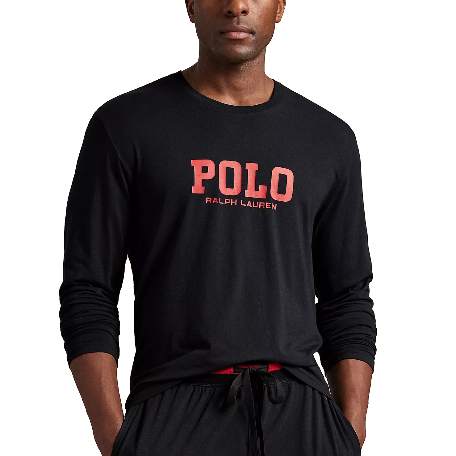 A man wearing a black long-sleeve shirt with \“POLO Ralph Lauren\“ printed in red on the front, paired with matching black drawstring pants.