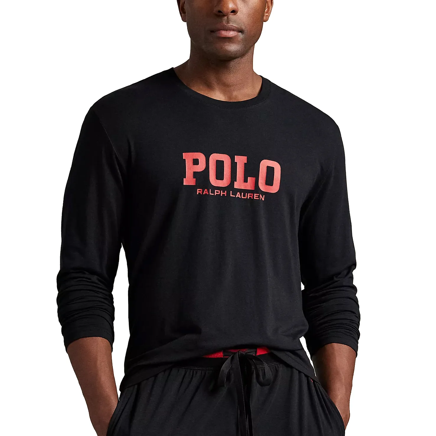 A man wearing a black long-sleeve shirt with \“POLO Ralph Lauren\“ printed in red on the front, paired with matching black drawstring pants.