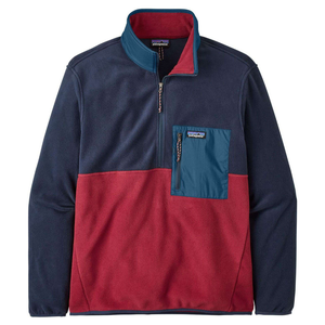 A color-blocked, half-zip fleece pullover featuring red and navy sections with a teal chest pocket, suitable for outdoor wear.
