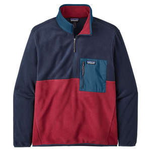 A color-blocked, half-zip fleece pullover featuring red and navy sections with a teal chest pocket, suitable for outdoor wear.