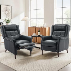 Two dark-colored reclining chairs with tufted backs and cushioned armrests are displayed in a modern living room setting, featuring a light area rug, a wooden sideboard, a floor lamp, and a small round coffee table with drinks.